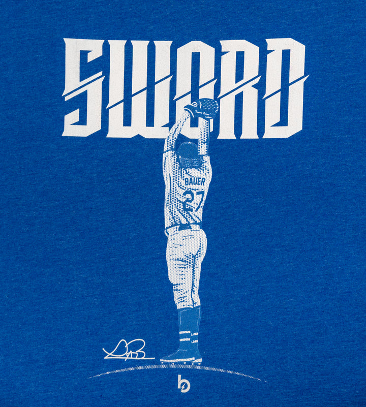 Trevor Bauer Outage sword tee up close overhead