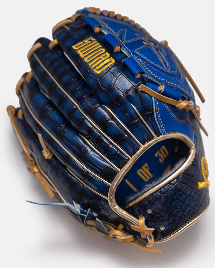 Blue baseball glove with gold accents on a white background