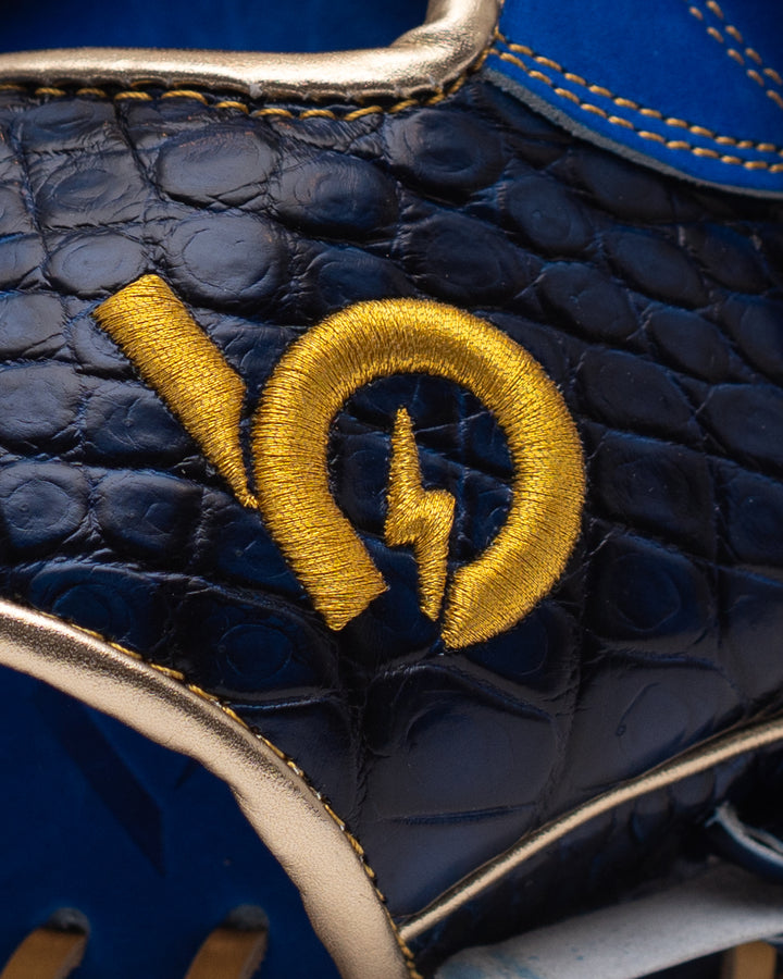 Close-up of a blue leather product with a gold logo on a blue background