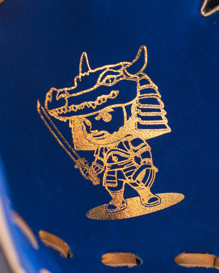 Gold embossed design of a warrior on a blue background